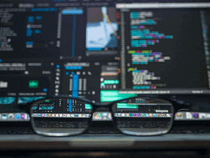 Reading glasses in front of computer screens